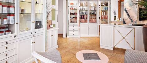 A well-lit room with white cabinetry, a small round table, and wicker chairs.