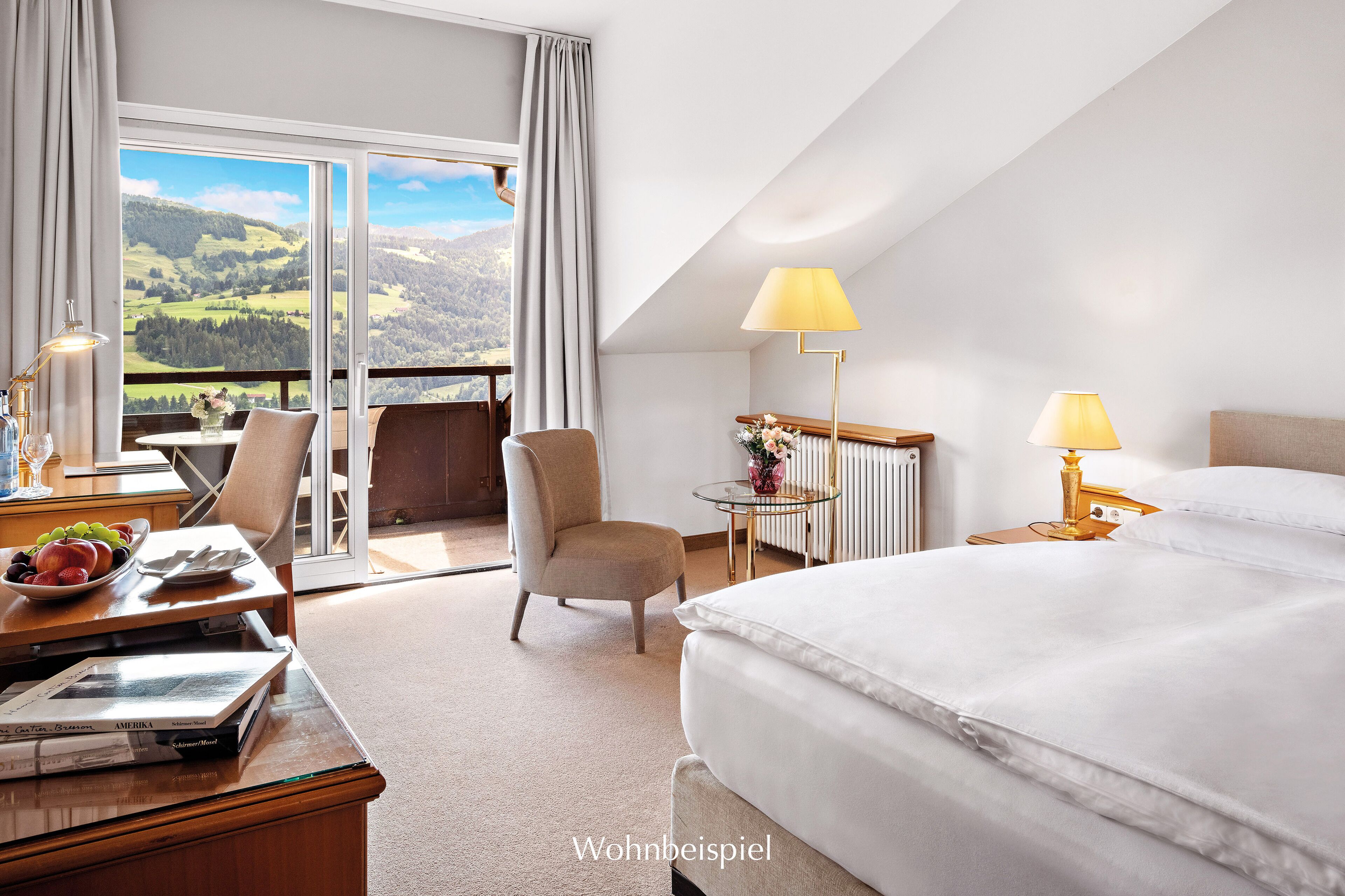 A hotel room with a bed, a chair, a table with a lamp, and a view of the outdoors.