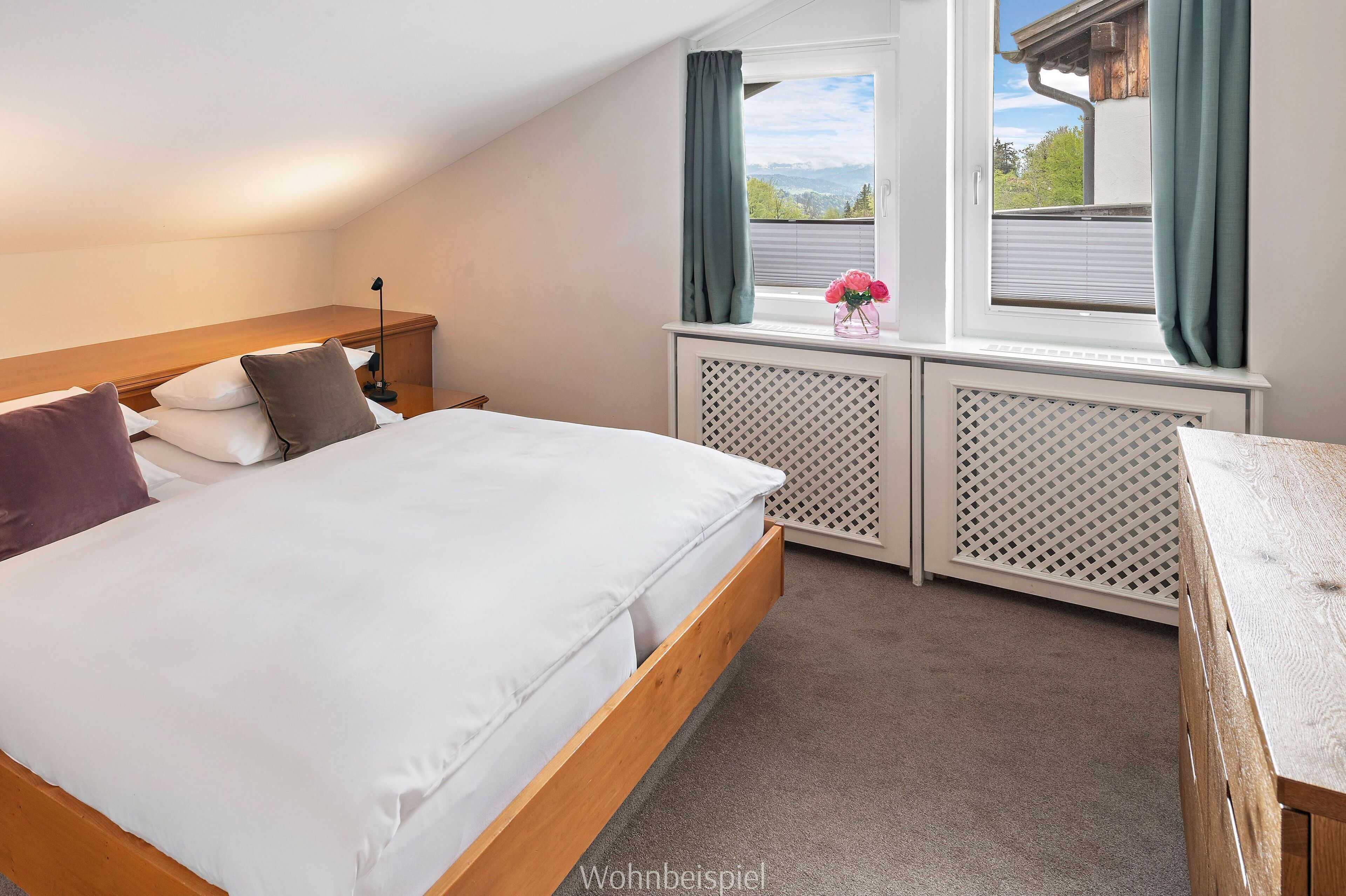 A bedroom with a wooden bed, a nightstand, a window with curtains, and a view of the outdoors.
