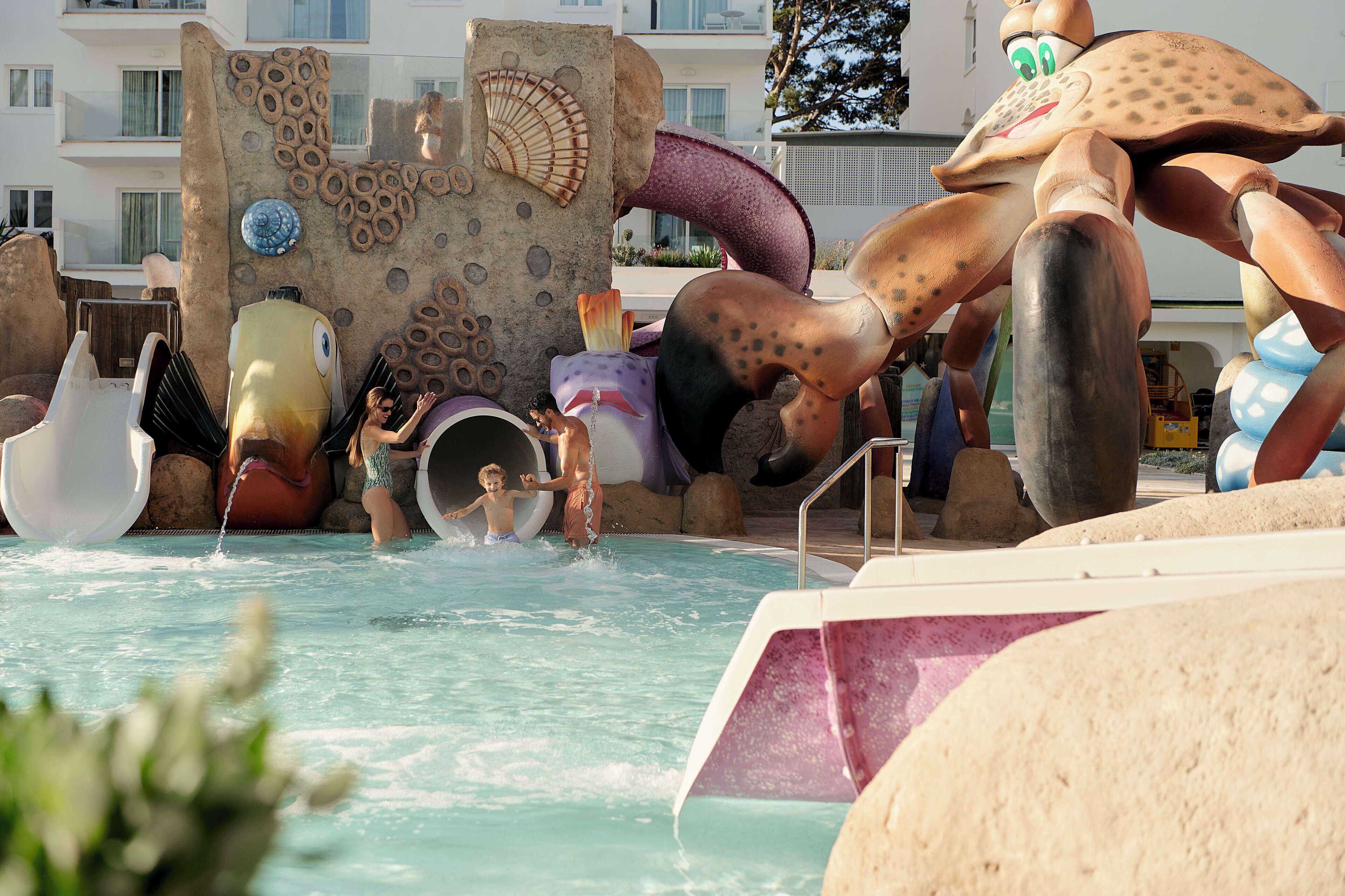 A water park with a large octopus sculpture and a castle-like structure.