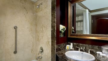 A bathroom with a bathtub, a sink, and a shower.