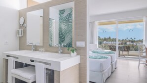 A modern bathroom with a large mirror, two sinks, and a towel rack. - Iberostar Waves Playa Gaviotas -All Inclusive (Pajara)