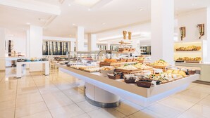 A spacious, well-lit buffet area with a variety of food options displayed on a central island. - Iberostar Waves Las Dalias -All Inclusive (Adeje)