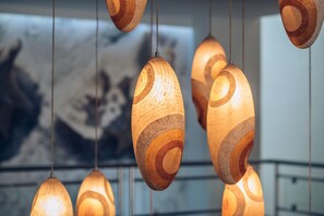 A series of hanging wooden light fixtures with a spiral design.
