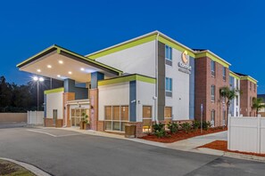 A Comfort Inn & Suites hotel with a brick facade, large windows, and a covered entrance.