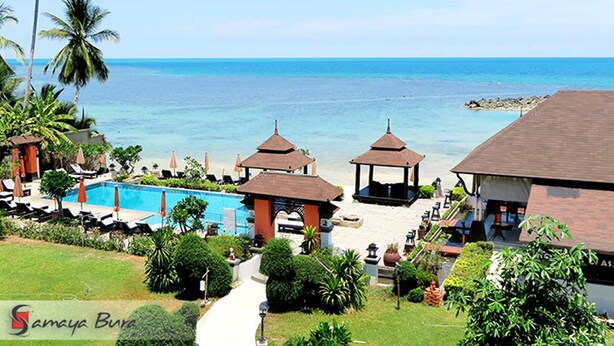 A resort with a pool, beach umbrellas, and gazebos overlooking the ocean. - Samaya Wellness Resort (Koh Samui)