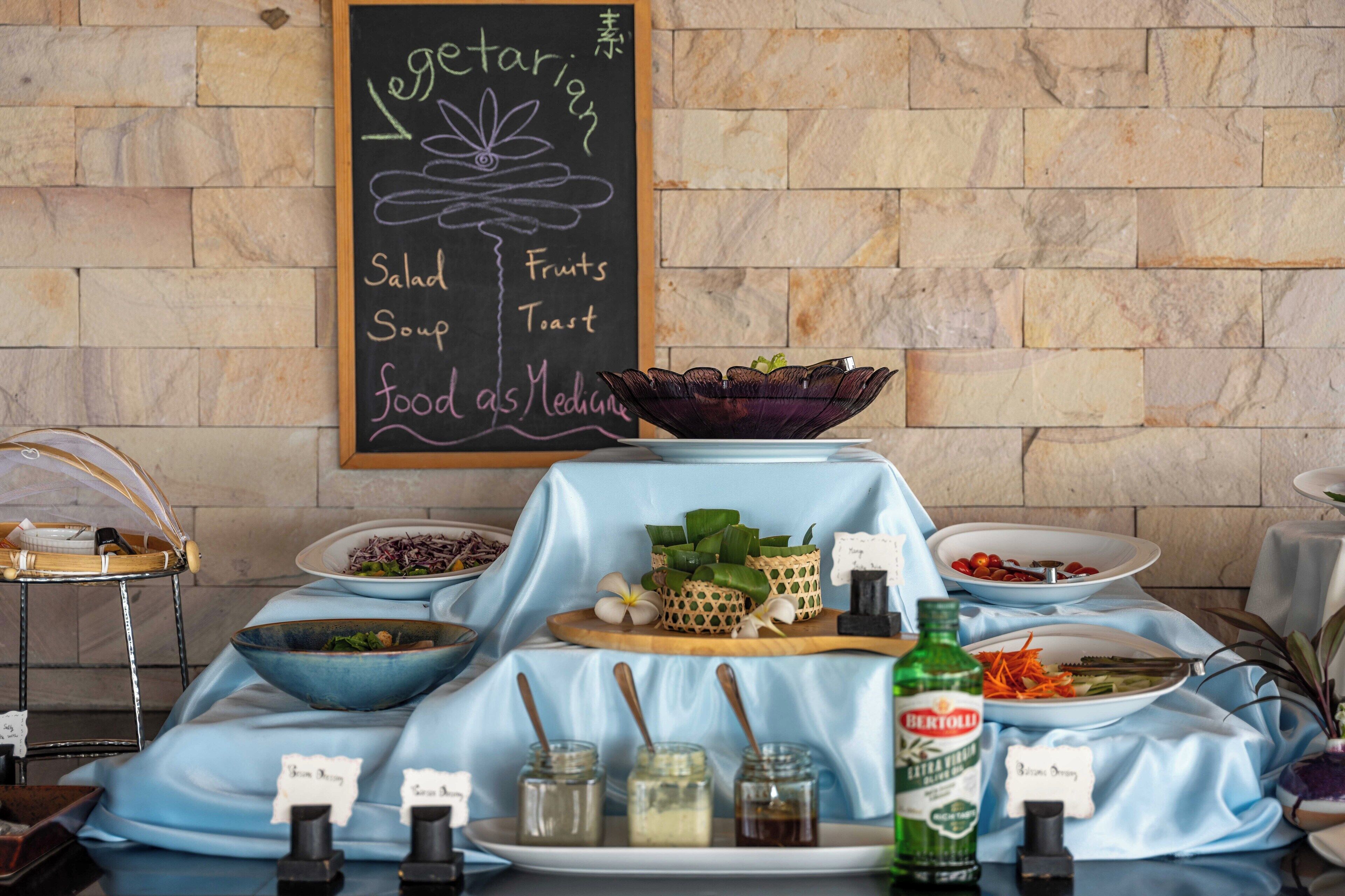 A buffet setup with various food items and condiments.