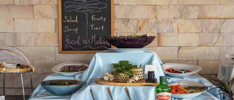 A buffet setup with various food items and condiments.