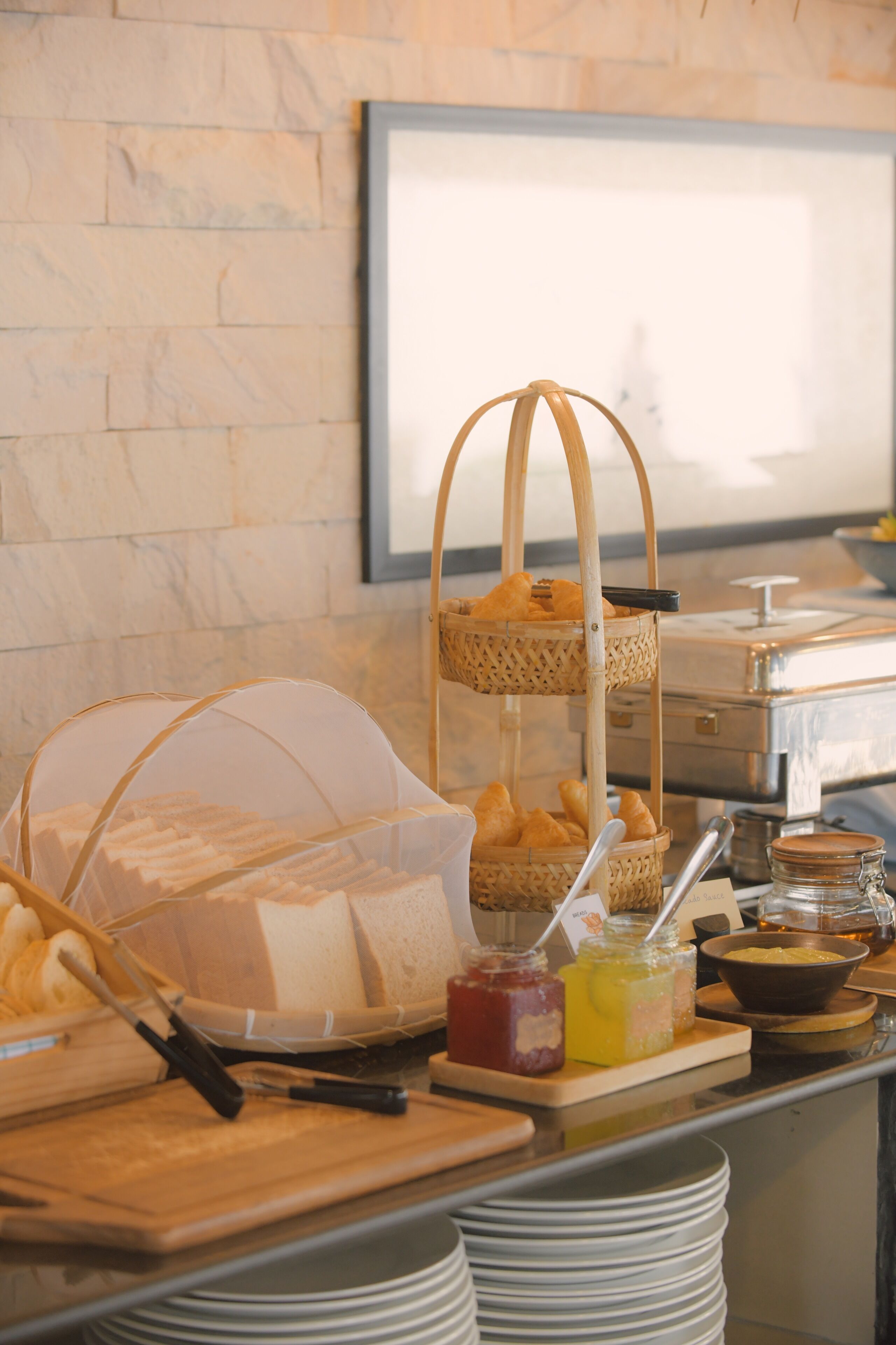 A buffet setup with various food items and condiments.