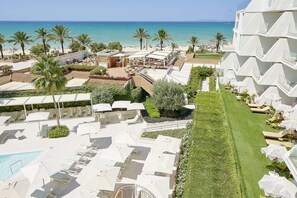 A resort with a pool, sun loungers, and a view of the beach and ocean. - Iberostar Selection Playa de Palma (Palma de Mallorca)