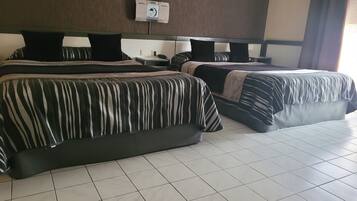 A hotel room with two beds, a wall-mounted air conditioning unit, and a tiled floor.