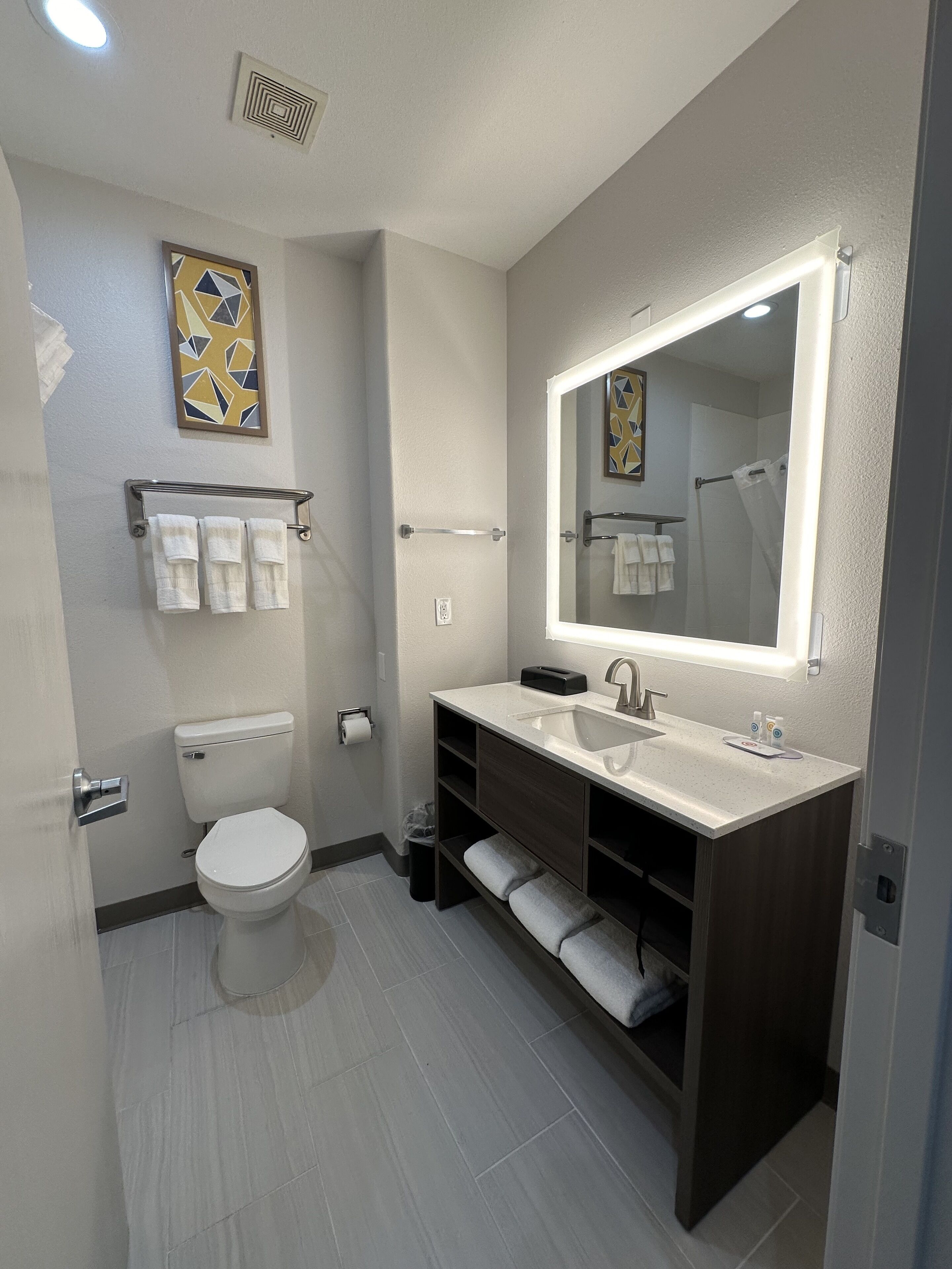 Une salle de bain moderne équipée de toilettes, d’un lavabo et d’un meuble-lavabo.