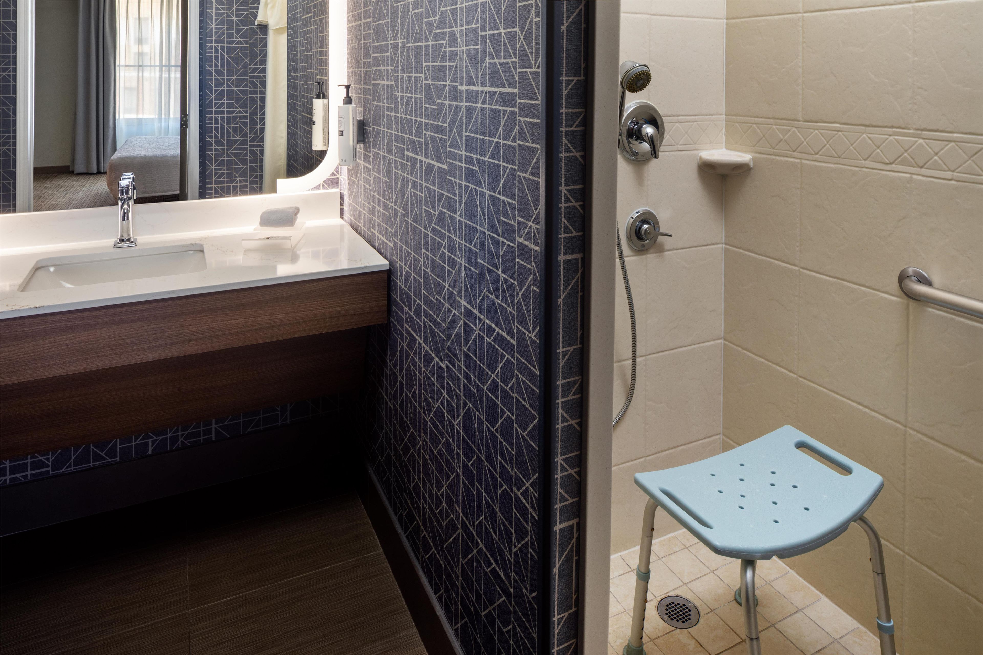 A bathroom with a bathtub, a shower, and a sink.