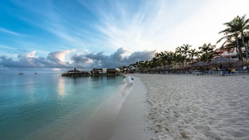 On the beach, white sand, free beach cabanas, sun loungers