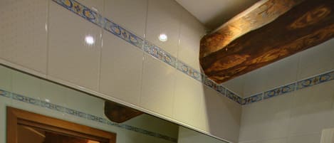 A bathroom with a sink, mirror, and towel rack.