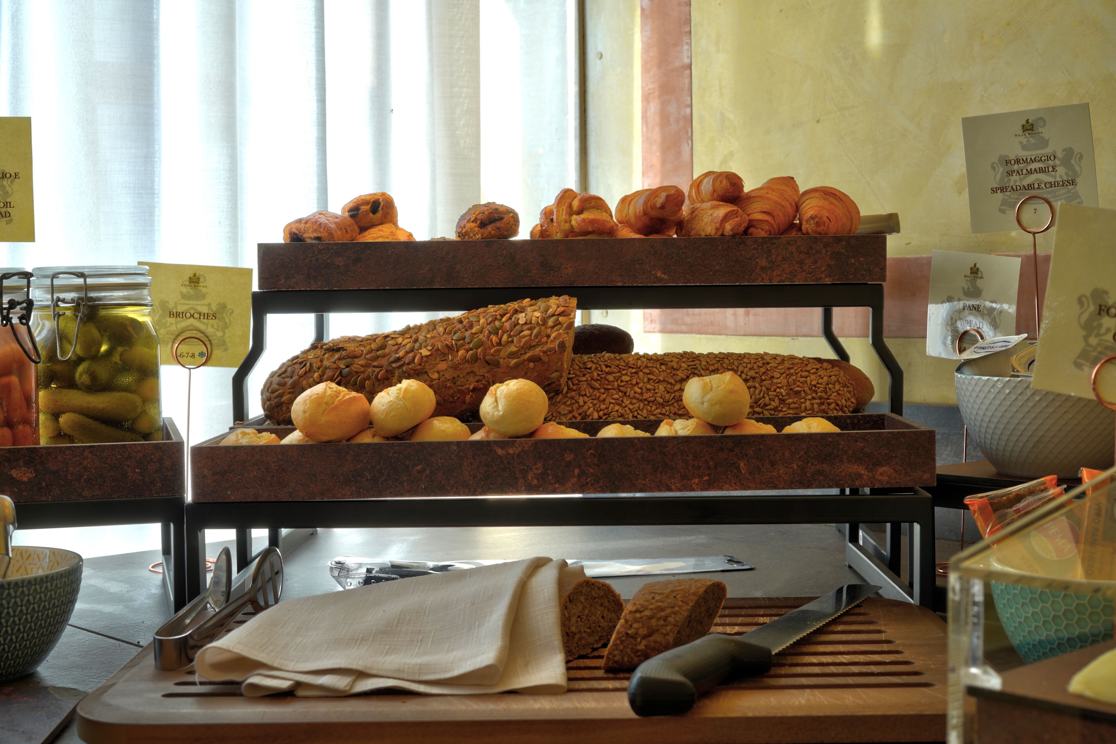 Mostrador de panadería con diversos productos horneados y una tabla de cortar con un cuchillo.