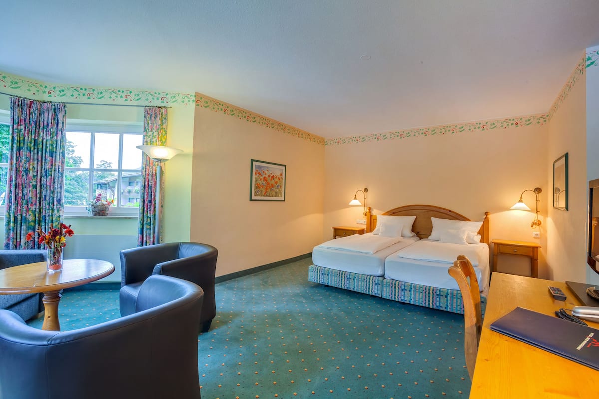 Superior Double Room | Living area | LCD TV, books