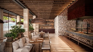 A modern outdoor dining area with a stone wall, wooden ceiling, and a bar with a stone facade. - Hacienda Tres Rios Resort, Spa & Nature Park-All Inclusive (Playa del Carmen)