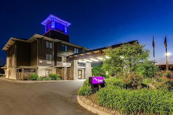 Enter through the covered walkway to the main doors of this hotel.