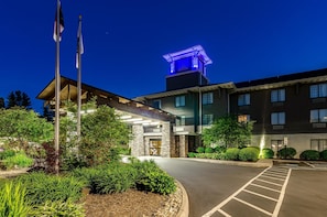 Welcome to our hotel, featuring a modern architectural design with a beautifully landscaped garden and a striking roof structure.