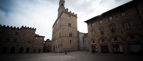 A historic building with a prominent tower and arched windows.
