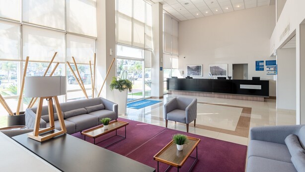 A spacious lobby with a reception desk, seating area, and large windows. - City Express by Marriott Tepotzotlan (Tepotzotlán)
