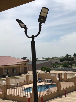A hotel with a swimming pool, a covered patio area, and a view of the surrounding landscape. - Texas Inn and Suites at La Joya (La Joya)