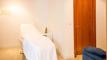 Cozy retreat with a single bed, bedside table, and comfortable seating area.