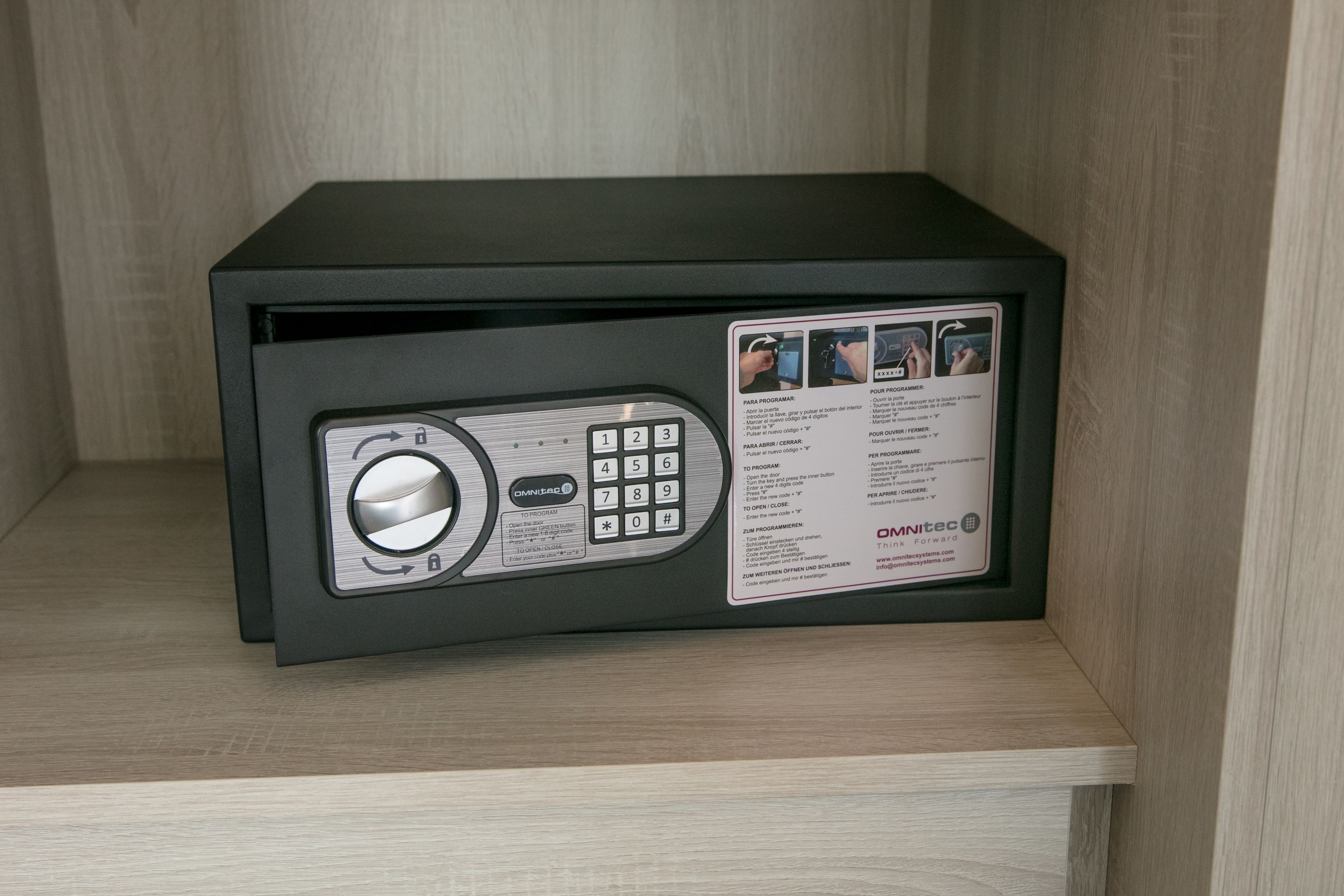 A black safe with a keypad and a small display.
