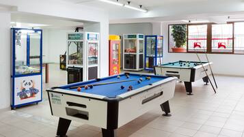 Enjoy a game of pool or challenge friends at one of two billiard tables, accompanied by arcade games and a cozy atmosphere.