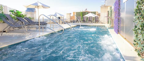 Seasonal outdoor pool, open noon to 8:00 PM, pool umbrellas
