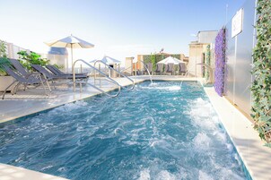 Seasonal outdoor pool, open noon to 8:00 PM, pool umbrellas