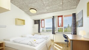 A hotel room with a large bed, a desk, and a view of the outdoors. - Hotel Edda Egilsstadir (Egilsstaðir)
