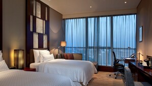 A hotel room with two beds, a desk, a chair, and a large window with curtains. - The Westin Beijing Chaoyang (Beijing)