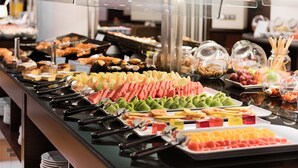 A buffet with various food items including fruits, pastries, and desserts. - NH Collection Paseo del Prado (Madrid)