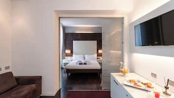 Een moderne hotelkamer met een bed, nachtkastjes, een televisie en een ontbijt tray.