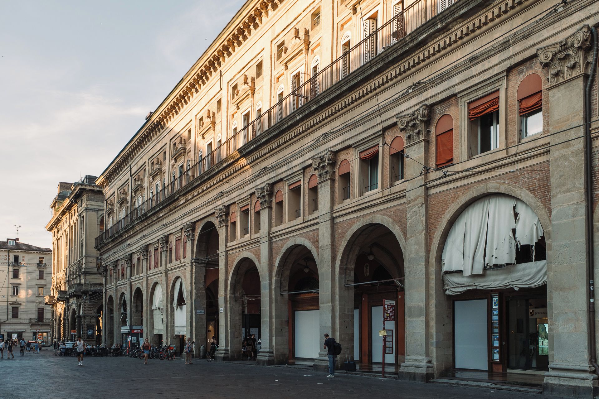 A historic building with classical architecture, featuring arched doorways and a central courtyard.
