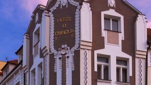 A hotel with a classic architectural style, featuring a prominent entrance with a balcony, multiple windows, and decorative elements. - Hotel U Divadla (Prague)