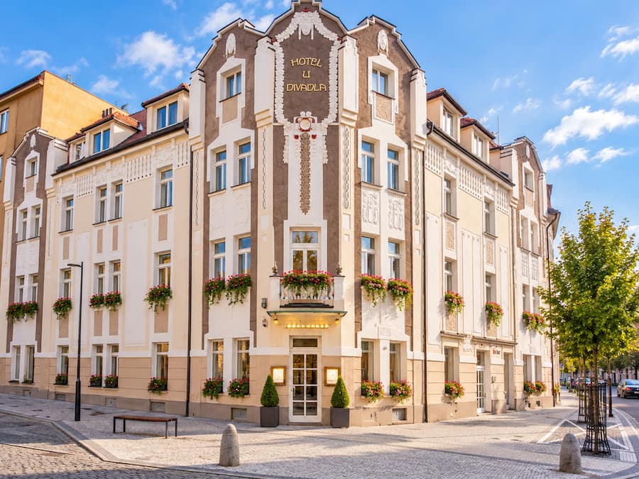 A historic building with a central entrance, multiple windows, and decorative elements.