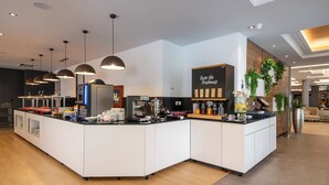 A modern coffee station with a self-serve coffee machine, a variety of coffee dispensers, and a sign that reads "Taste the Freshness." - Hotel Ivka (Dubrovnik)