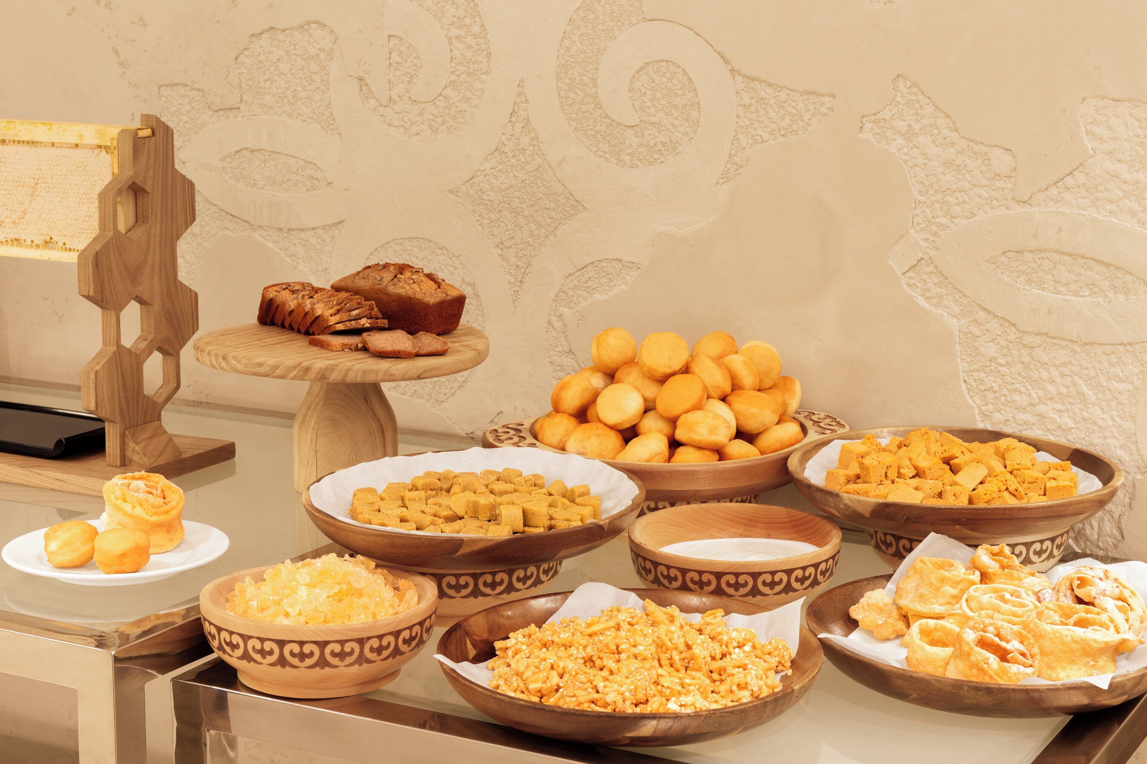 A buffet table with various baked goods and pastries.