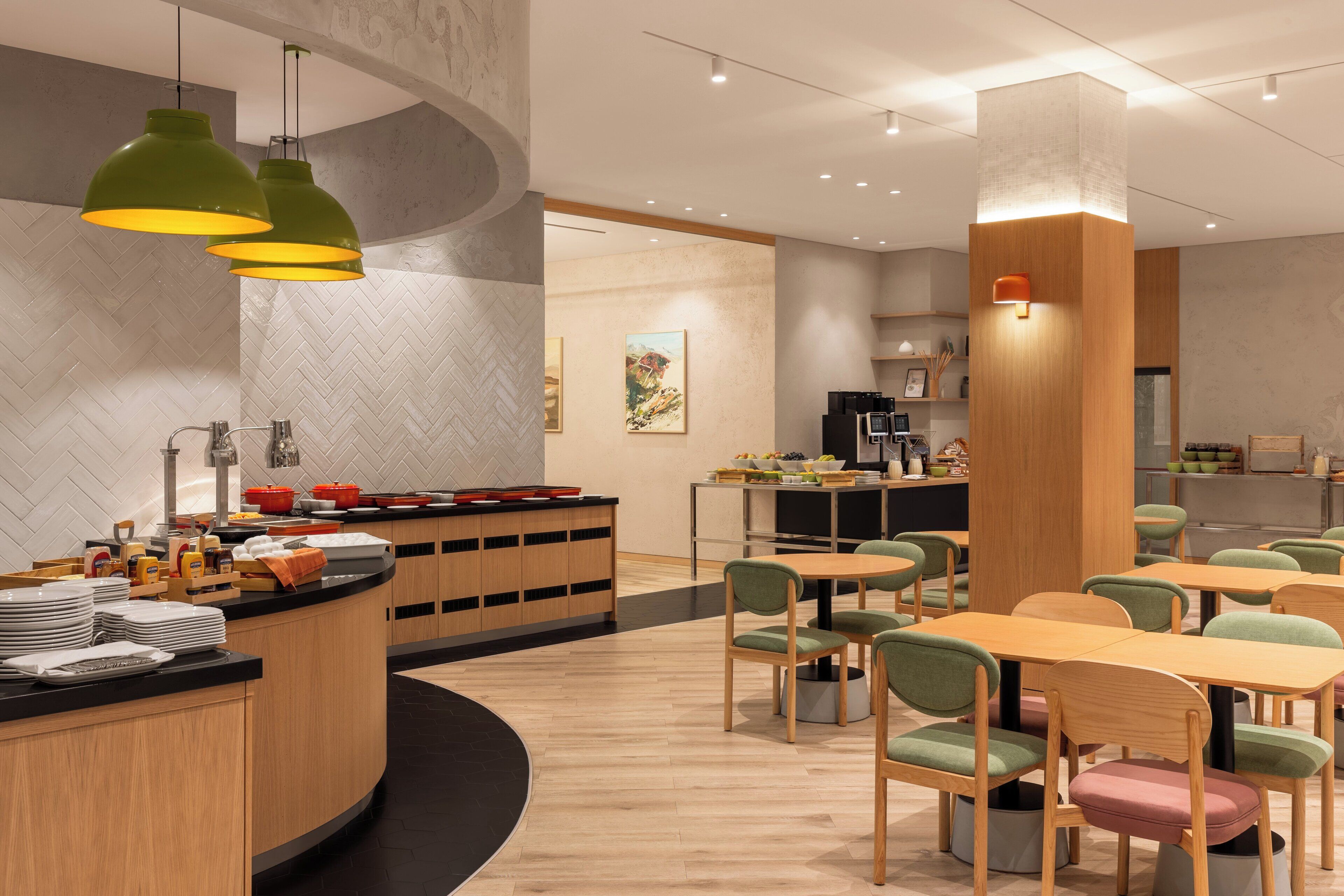 A modern dining area with a curved counter, multiple tables, and chairs.