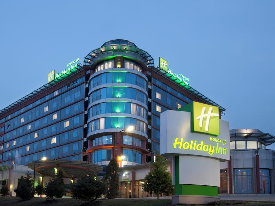 A Holiday Inn hotel with a modern design, featuring multiple floors and a prominent signage.