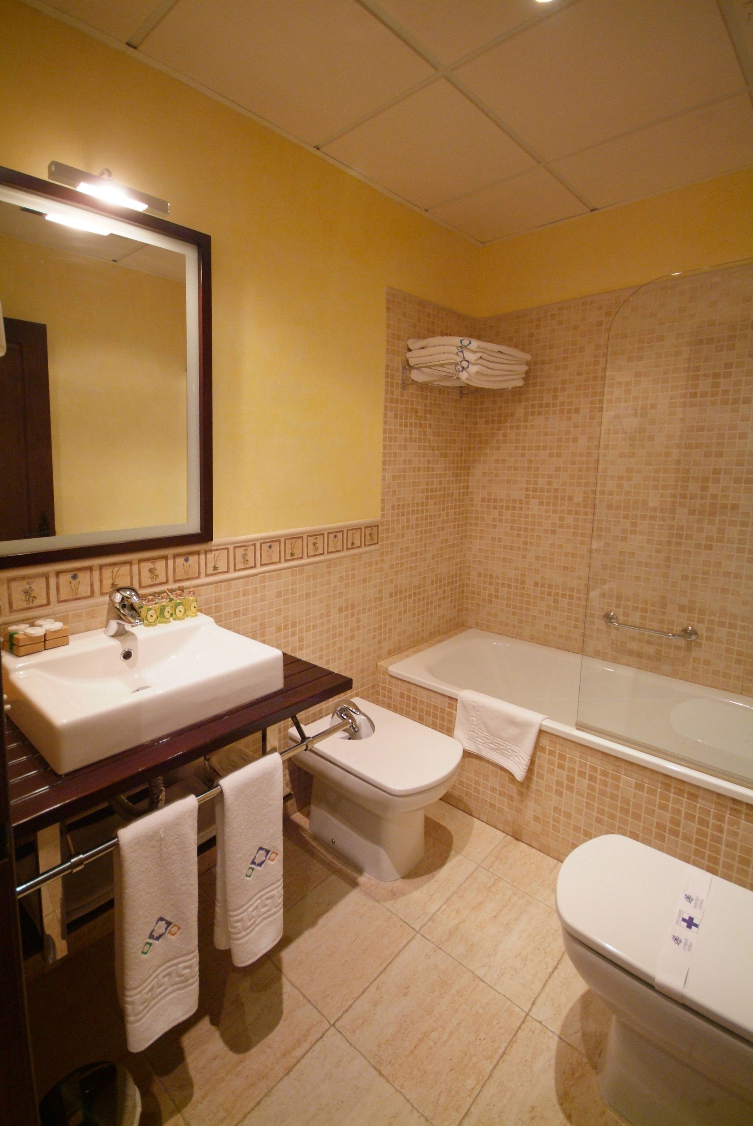 A bathroom with a sink, toilet, and bathtub.