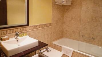 A bathroom with a sink, toilet, and bathtub.
