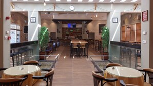 A spacious restaurant with high ceilings, modern lighting, and a central bar area. - Hotel Ezzahra Dar Tunis (Ezzahra)