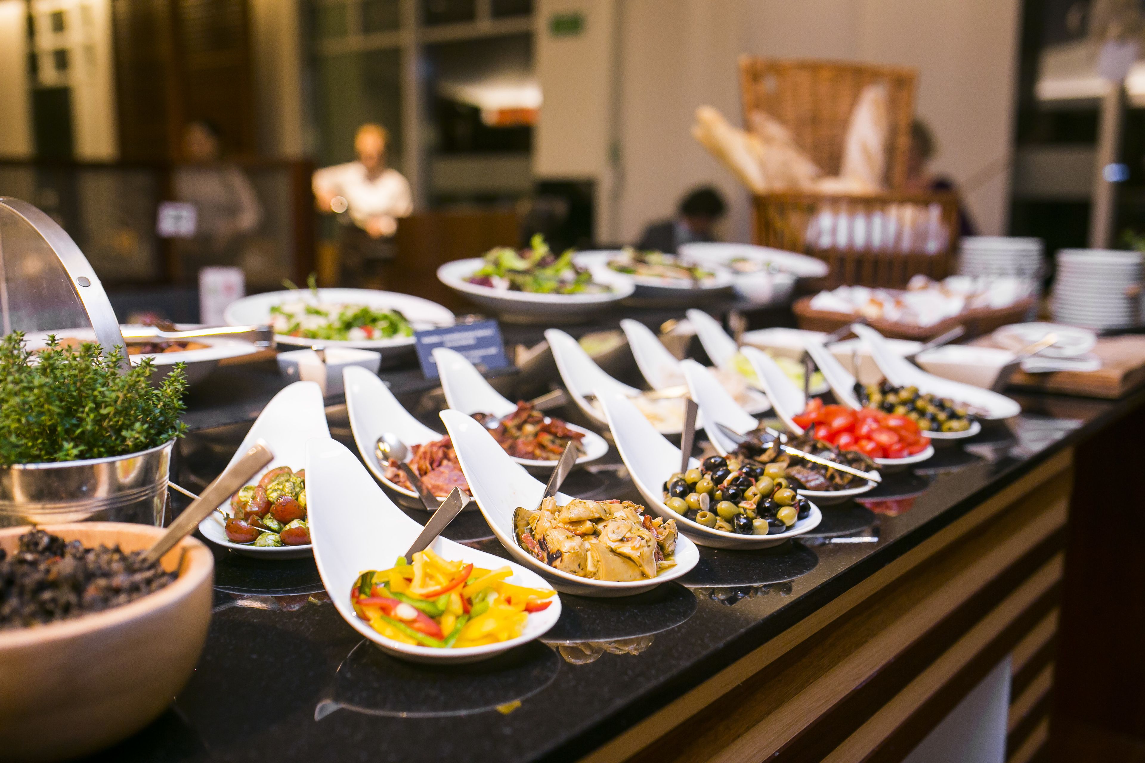 A buffet with various dishes arranged on a counter.