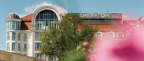 A hotel with a prominent arched window and a sign reading "SHERATON".