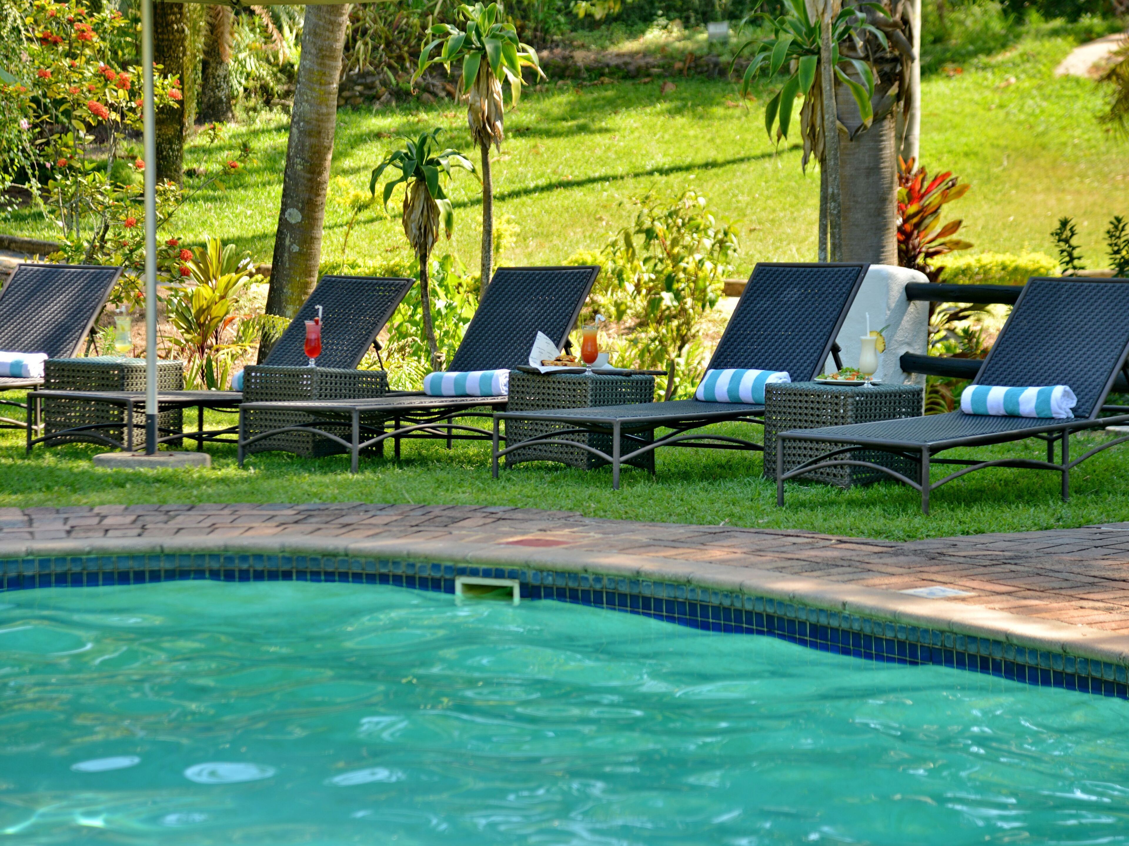A poolside area with lounge chairs and a swimming pool.