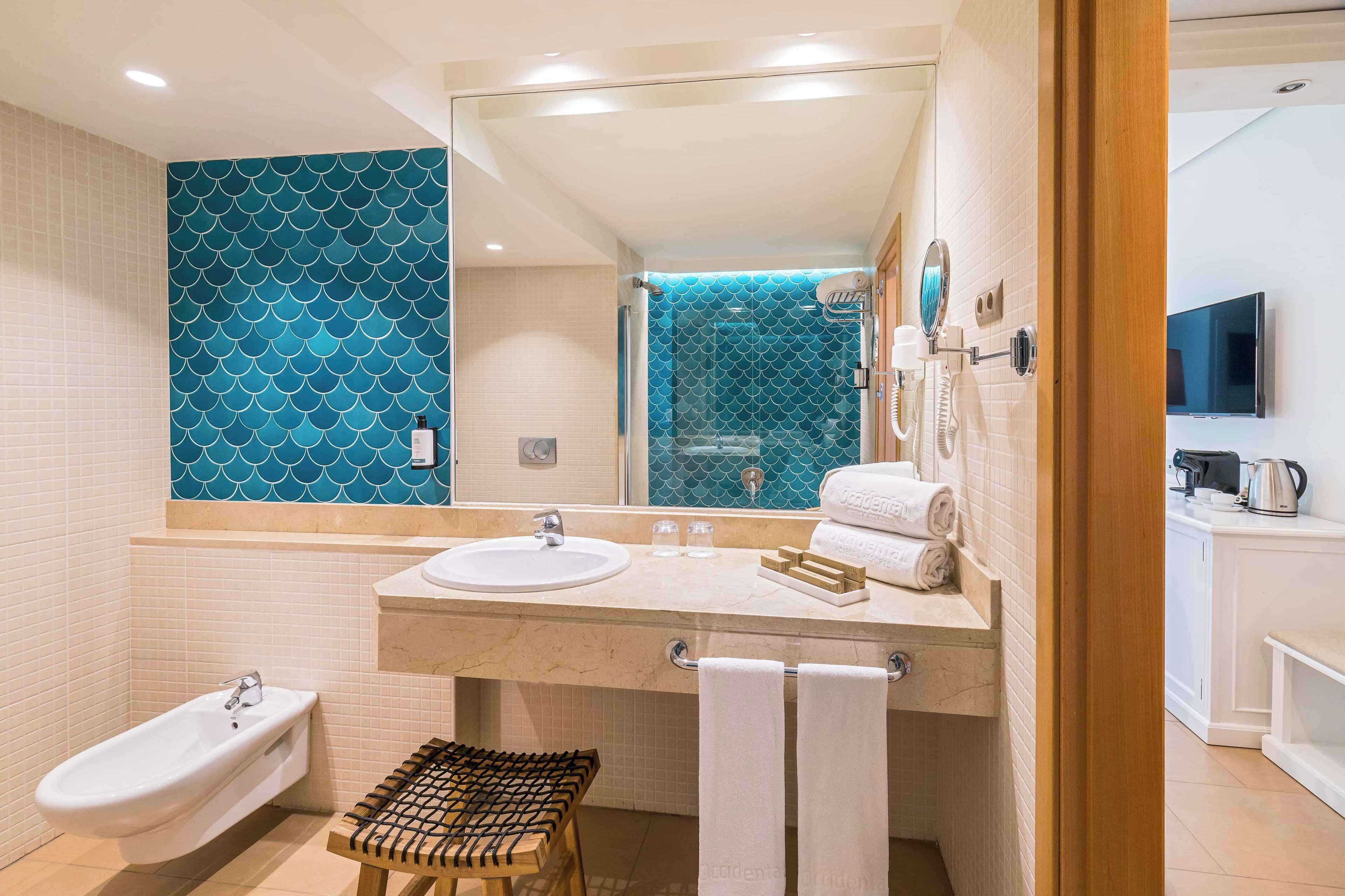 A modern bathroom with a bathtub, a sink, and a shower area.